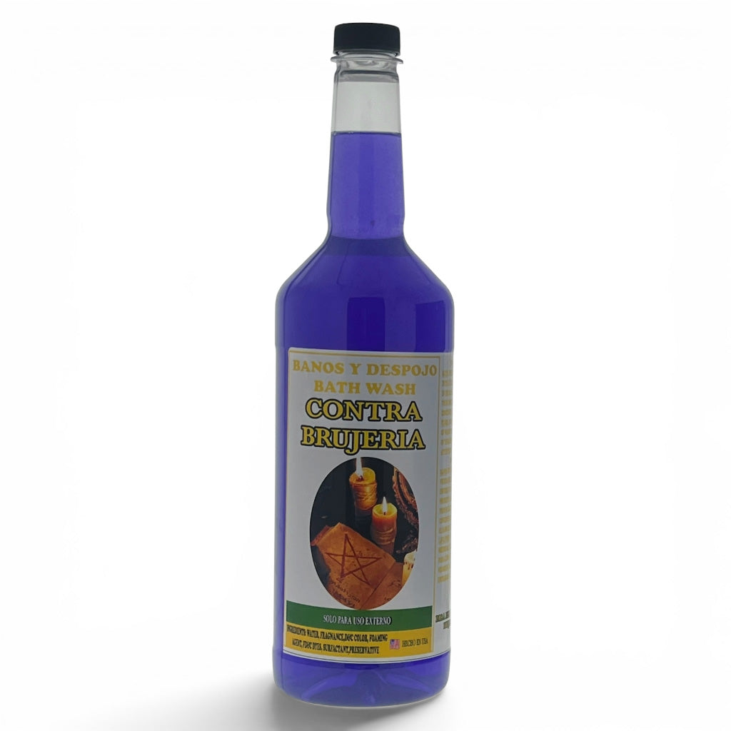 A bottle of purple-blue bath wash with a black cap and a cream-colored label reading 'CONTRA BRUJERIA' and 'BATH WASH'.
