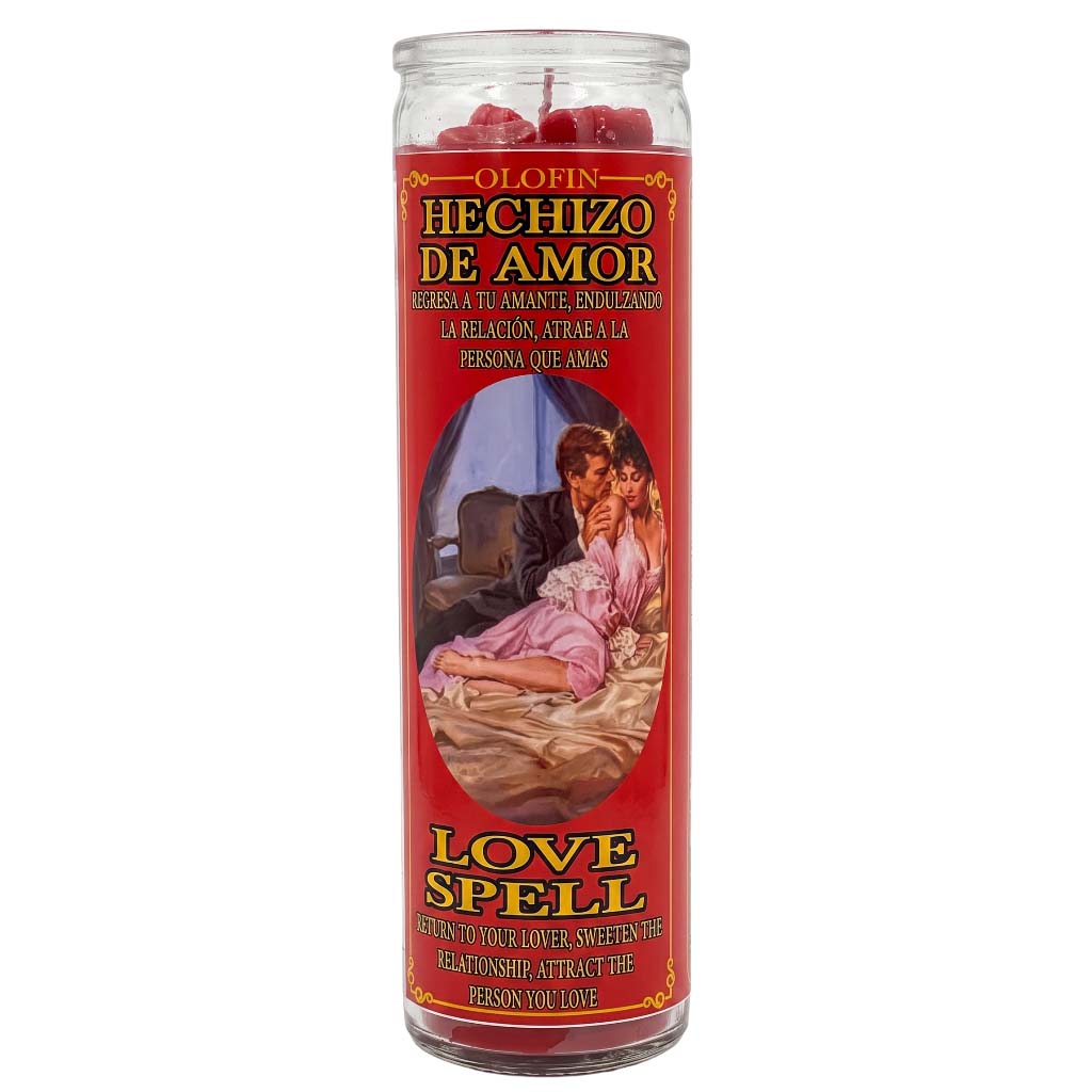A tall glass jar candle labeled 'Olofin Hechizo de Amor Love Spell' with a red label, yellow and black text, and an illustration of a couple in bed. Red wax is visible at the top of the clear glass container.