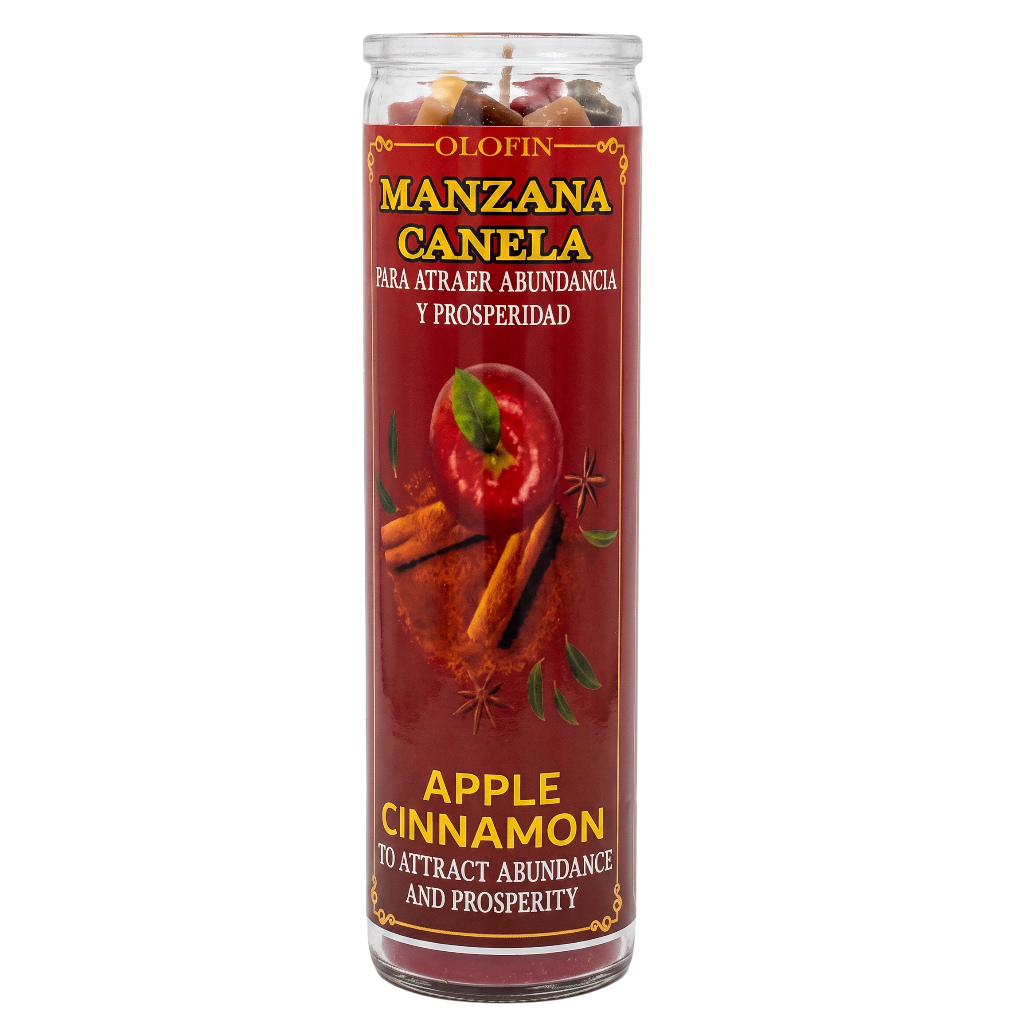 A tall glass jar candle with a red label reading 'Olofin Manzana Canela' and 'Apple Cinnamon,' shown on a plain white background. The candle contains cinnamon sticks and apple pieces visible at the top, and the front label includes cinnamon, star anise, and apple imagery.