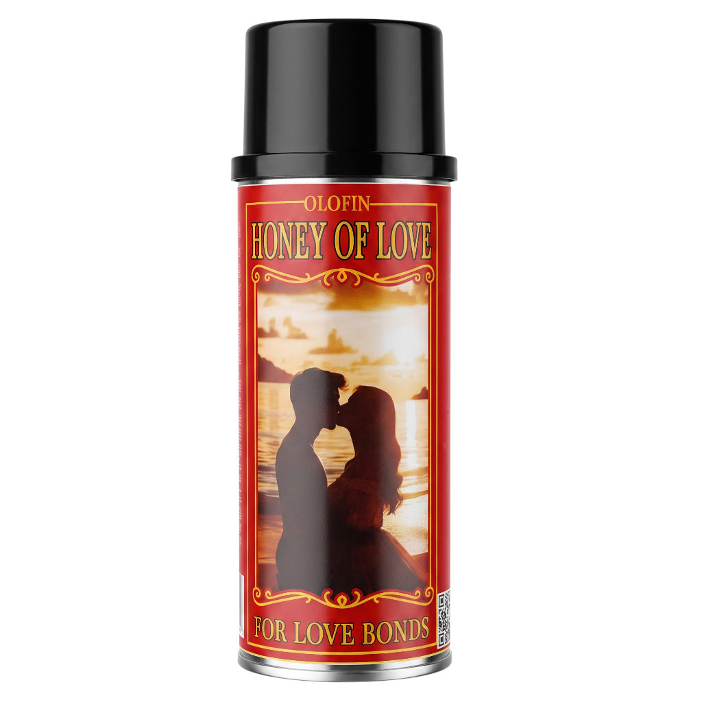 A can of Olofin Honey of Love perfume spray with a black cap and a red label featuring a silhouette of a kissing couple against a sunset.