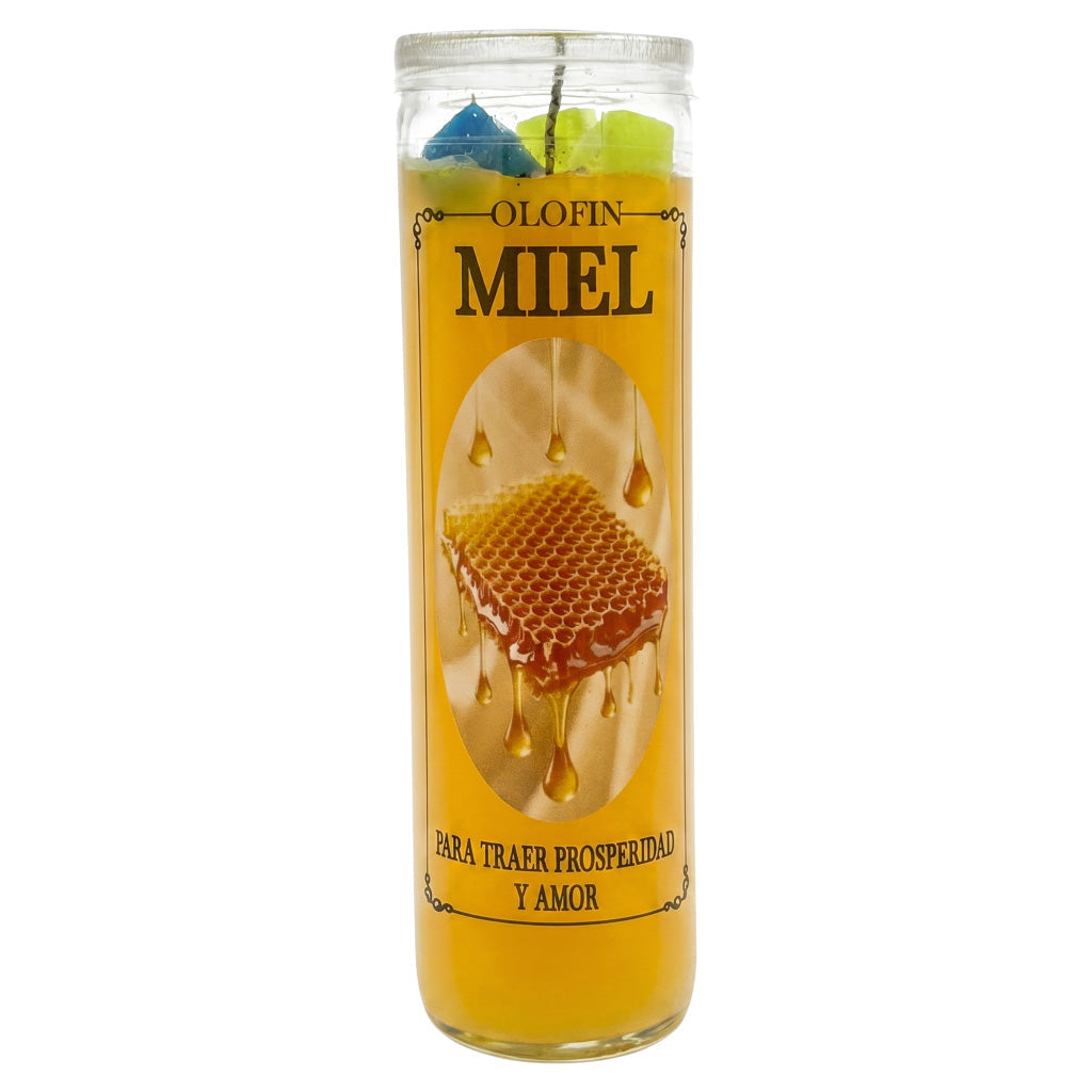 A tall glass jar candle filled with golden yellow wax and topped with blue and green wax pieces. The label reads 'OLOFIN MIEL' with an image of honeycomb dripping with golden honey.