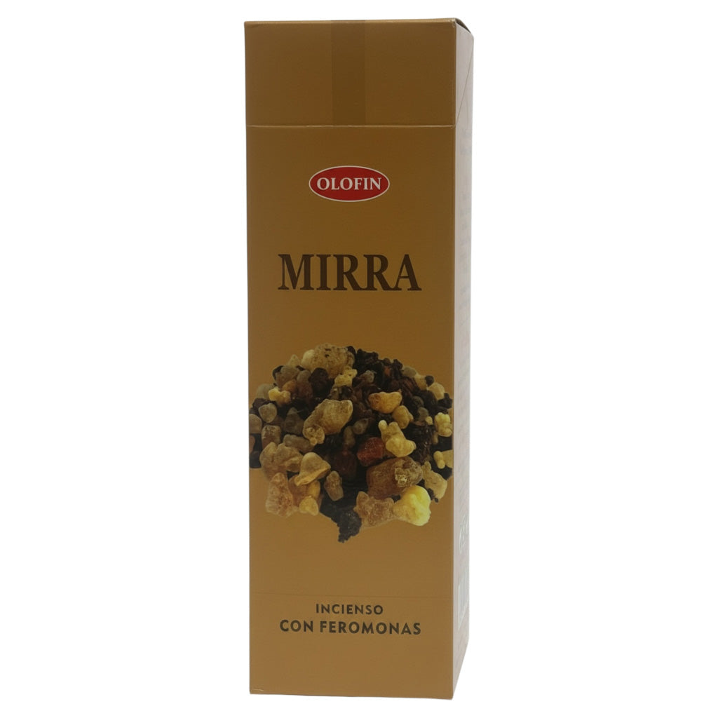 A tall rectangular Olofin Mirra incense box with a metallic gold finish, featuring a photo of dried herbs and the text 'MIRRA' and 'INCIENSO CON FEROMONAS' on a plain white background.