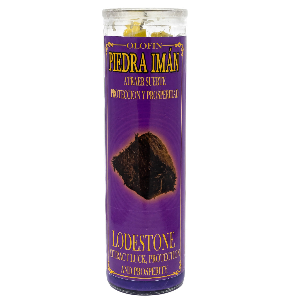 A tall cylindrical glass jar containing yellow Olofin Piedra Imán (Lodestone) crystals, set inside a purple label with gold lettering.