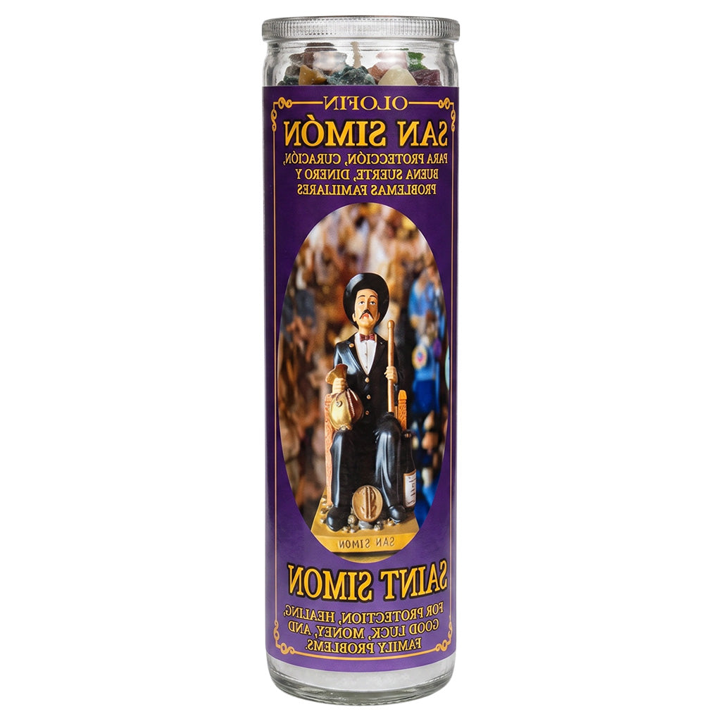 A tall glass jar prayer candle with a purple label featuring Saint Simon, shown on a plain white background. The label includes Spanish and English text and an illustration of the saint.