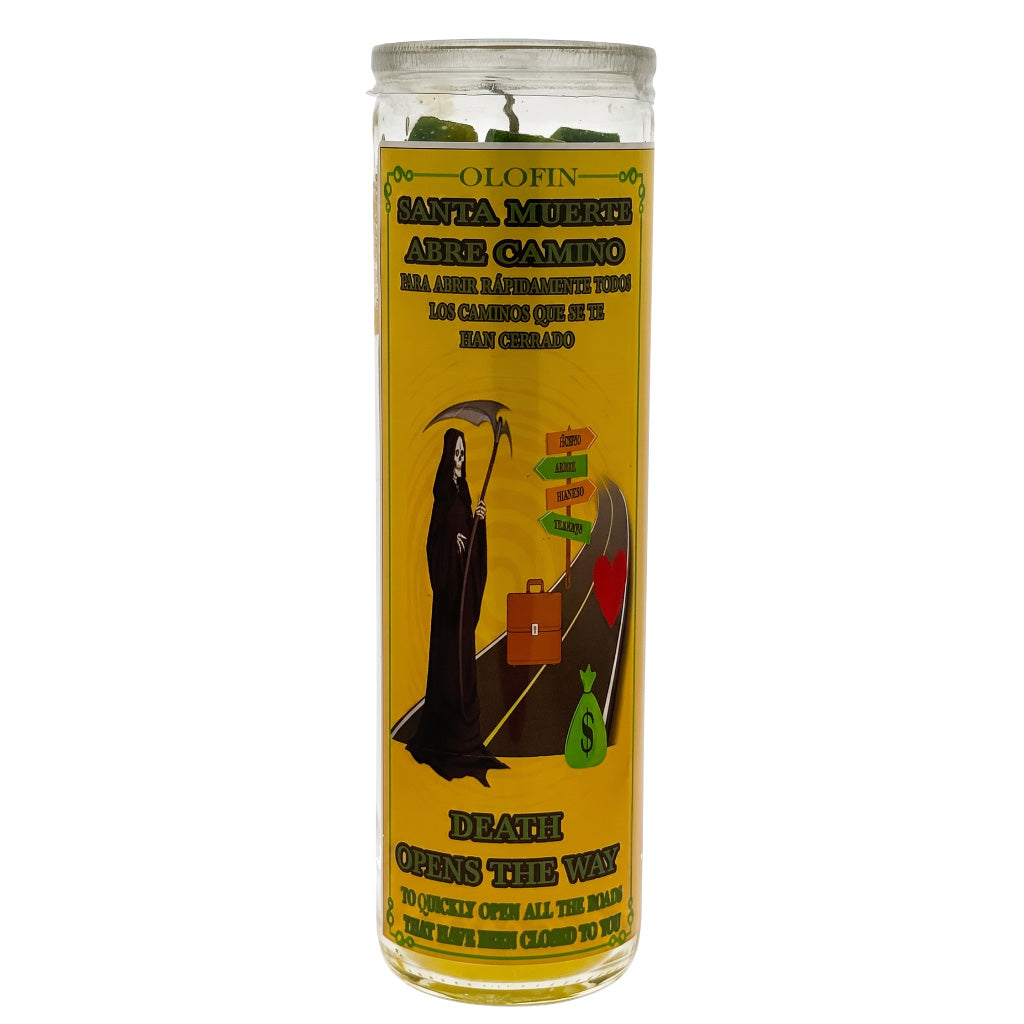 A tall glass jar candle with a yellow label featuring Santa Muerte artwork and Spanish text, photographed on a plain white background.