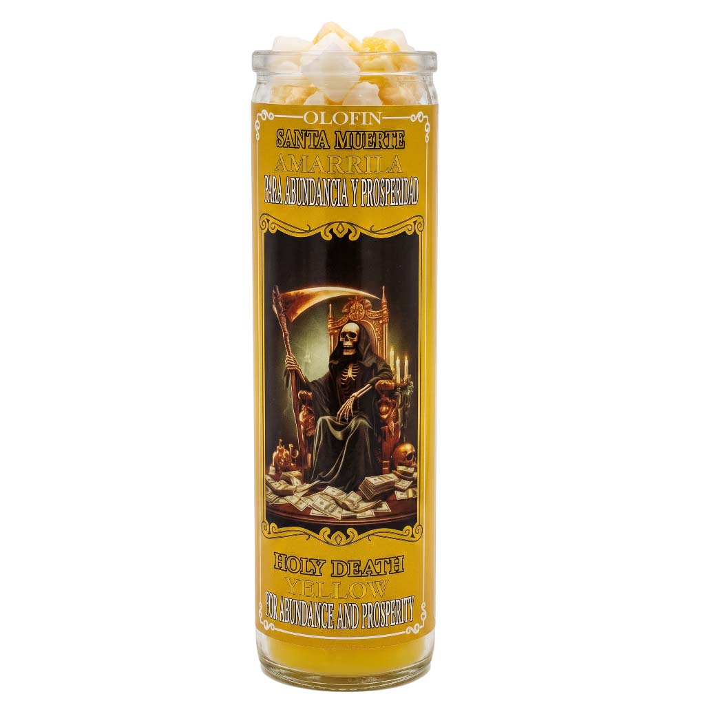 A tall glass jar candle with a yellow and black label featuring Santa Muerte artwork, topped with white popcorn pieces, on a plain white background.