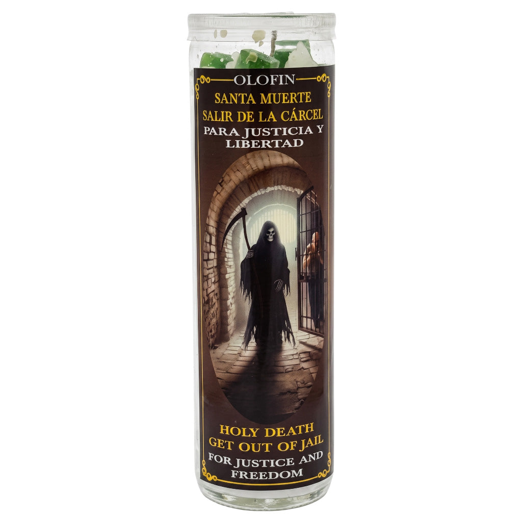A tall glass prayer candle with a printed label featuring a grim reaper standing in a prison cell. The label reads 'OLOFIN SANTA MUERTE SALIR DE LA CÁRCEL PARA JUSTICIA Y LIBERTAD' and 'HOLY DEATH GET OUT OF JAIL FOR JUSTICE AND FREEDOM.
