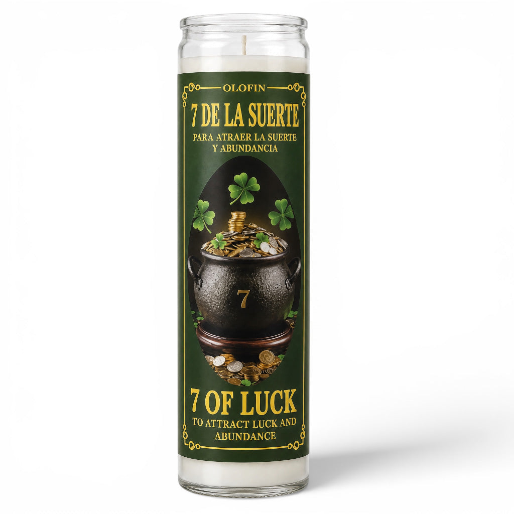 A tall glass jar candle with a green and gold label featuring a pot of gold and shamrocks, labeled '7 DE LA SUERTE' and '7 OF LUCK' on a white background.