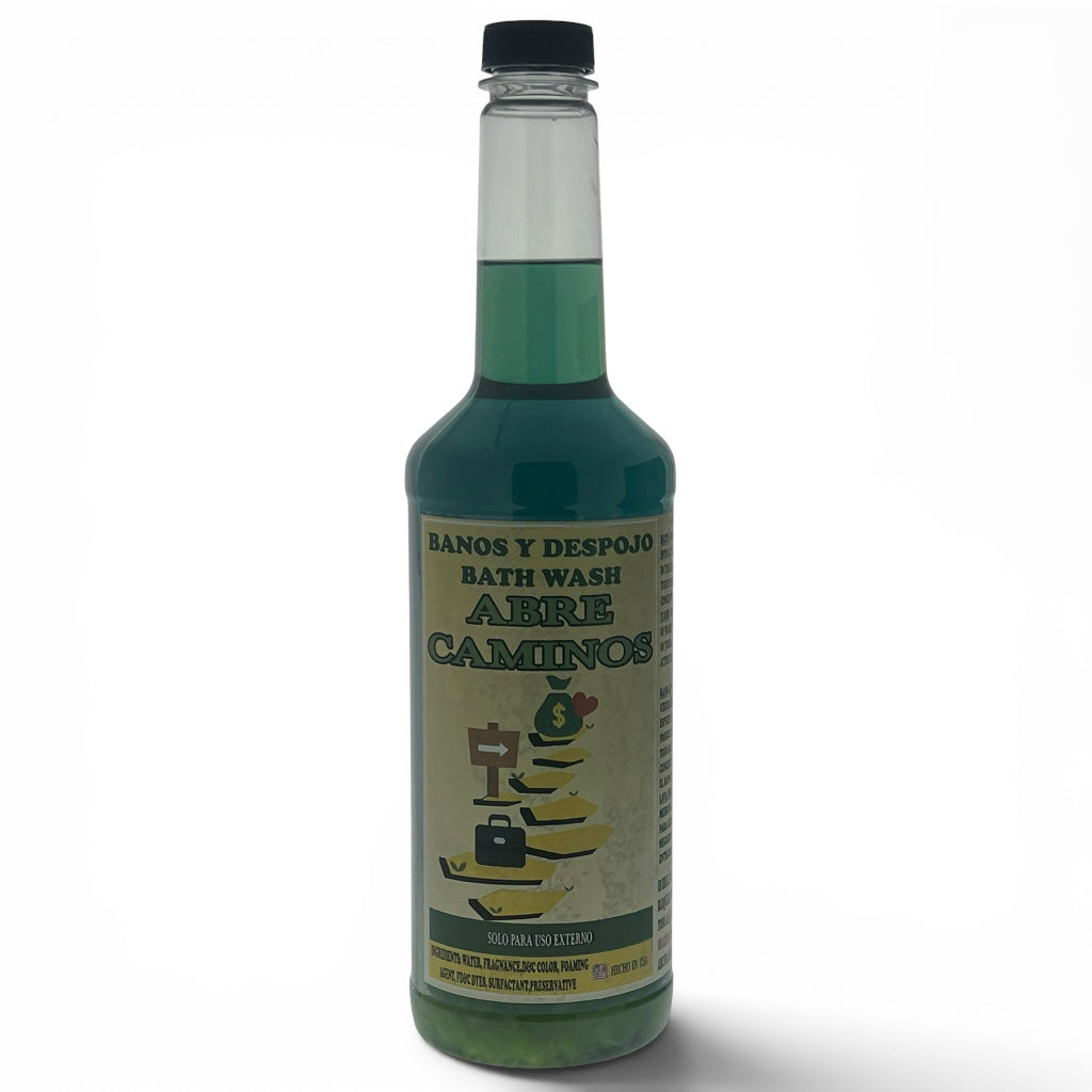 A bottle of Abre Caminos bath wash with green liquid inside, featuring a beige label with a tree illustration and a black cap, set against a plain white background.