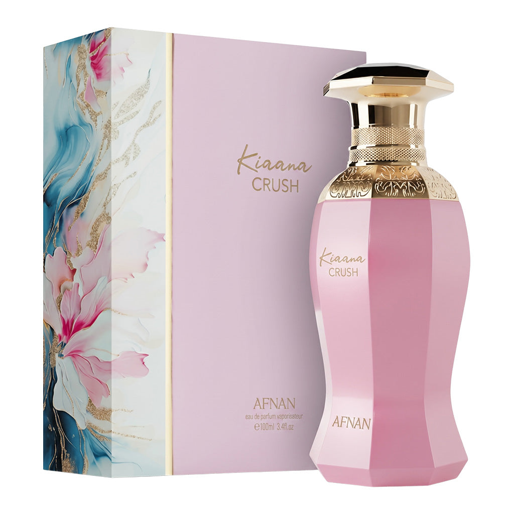 Pink perfume bottle with gold cap and floral packaging on a white background