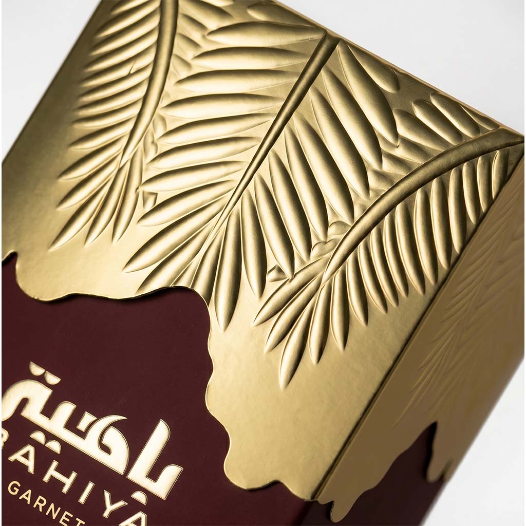 Close-up of a gold and brown product packaging with leaf patterns