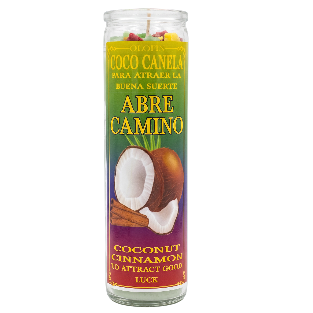 A tall glass jar candle with a colorful label reading 'Abre Camino' and 'Coconut Cinnamon' on a white background.