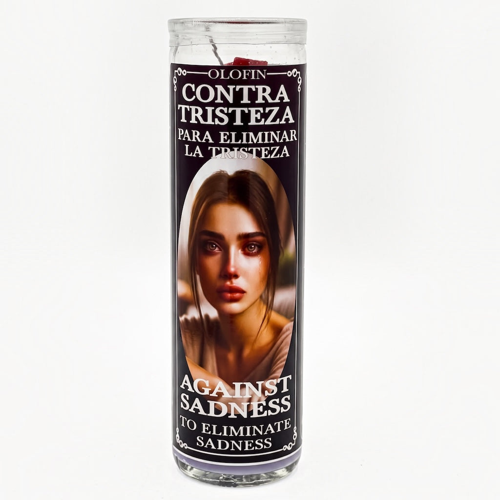 A tall glass prayer candle with a printed label featuring a woman's face and Spanish text reading 'Olofin Contra Tristeza' and 'Against Sadness,' shown on a plain light background.