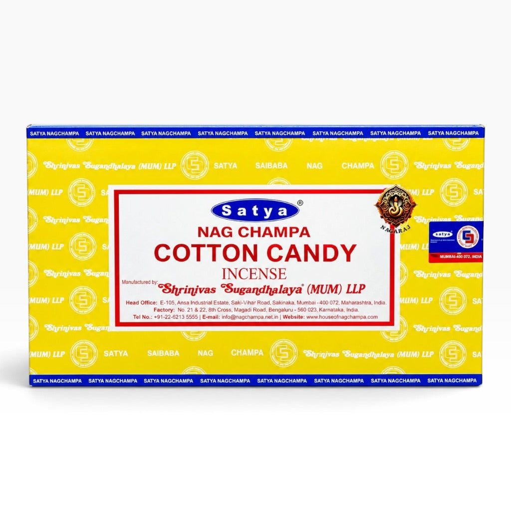 A rectangular box of Satya Nag Champa Cotton Candy Incense on a plain white background. The box is primarily bright yellow with blue borders, a large white center panel with red text, and repeated Satya branding.