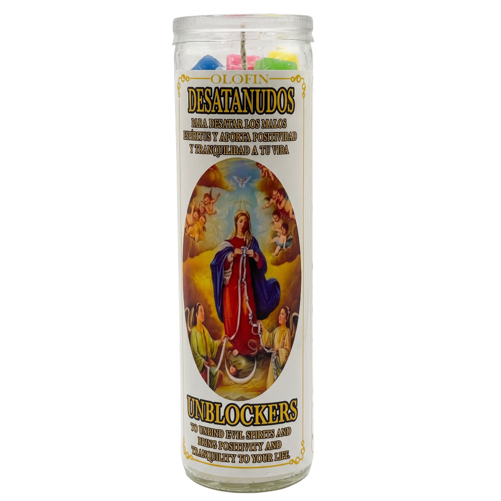 A tall glass prayer candle with a white label featuring a religious illustration of the Virgin Mary and Spanish text reading 'OLIVIN DESATANUDOS' and 'UNBLOCKERS'. Colorful wax pieces are visible at the top inside the clear glass container.