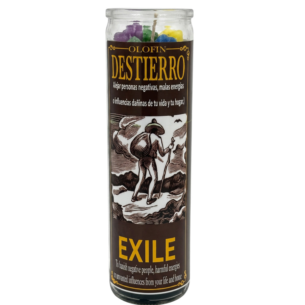 A tall glass jar candle labeled 'Olofin Destierro Exile' with a dark brown label, yellow text, and an illustration of a person standing on rocks. Multicolored wax pieces are visible at the top through the clear glass, on a white background.