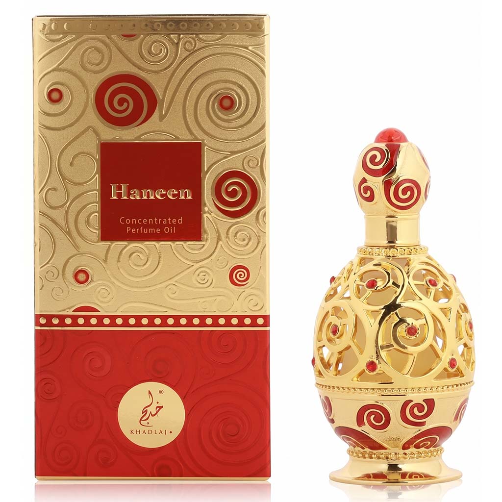 Gold and red Haneen concentrated perfume oil with packaging on a white background