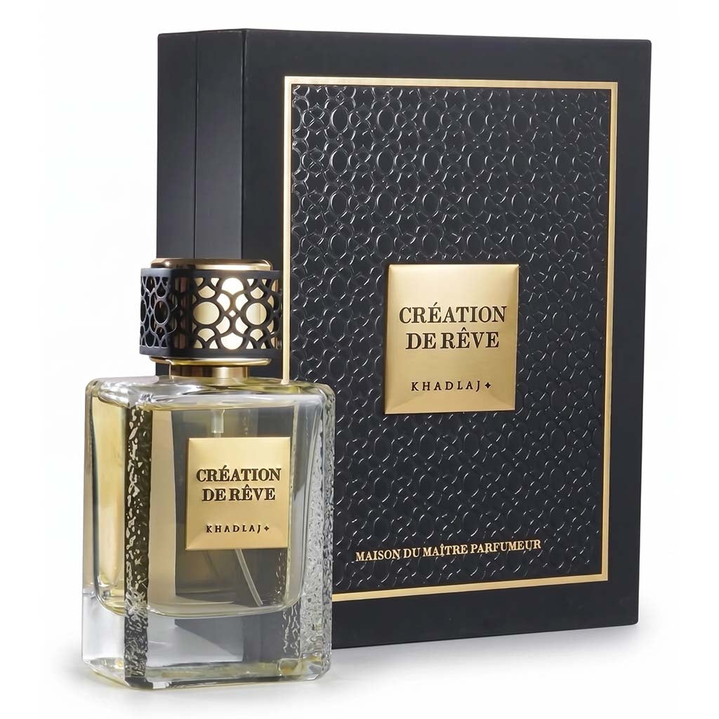Perfume bottle and packaging with 'Creation de Reve' branding on a white background